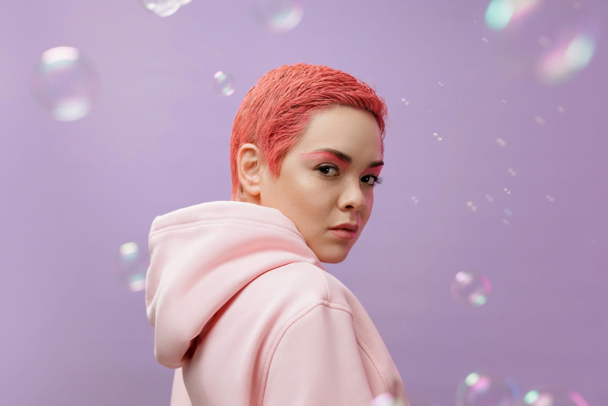 Portrait of a person in a pink hoodie