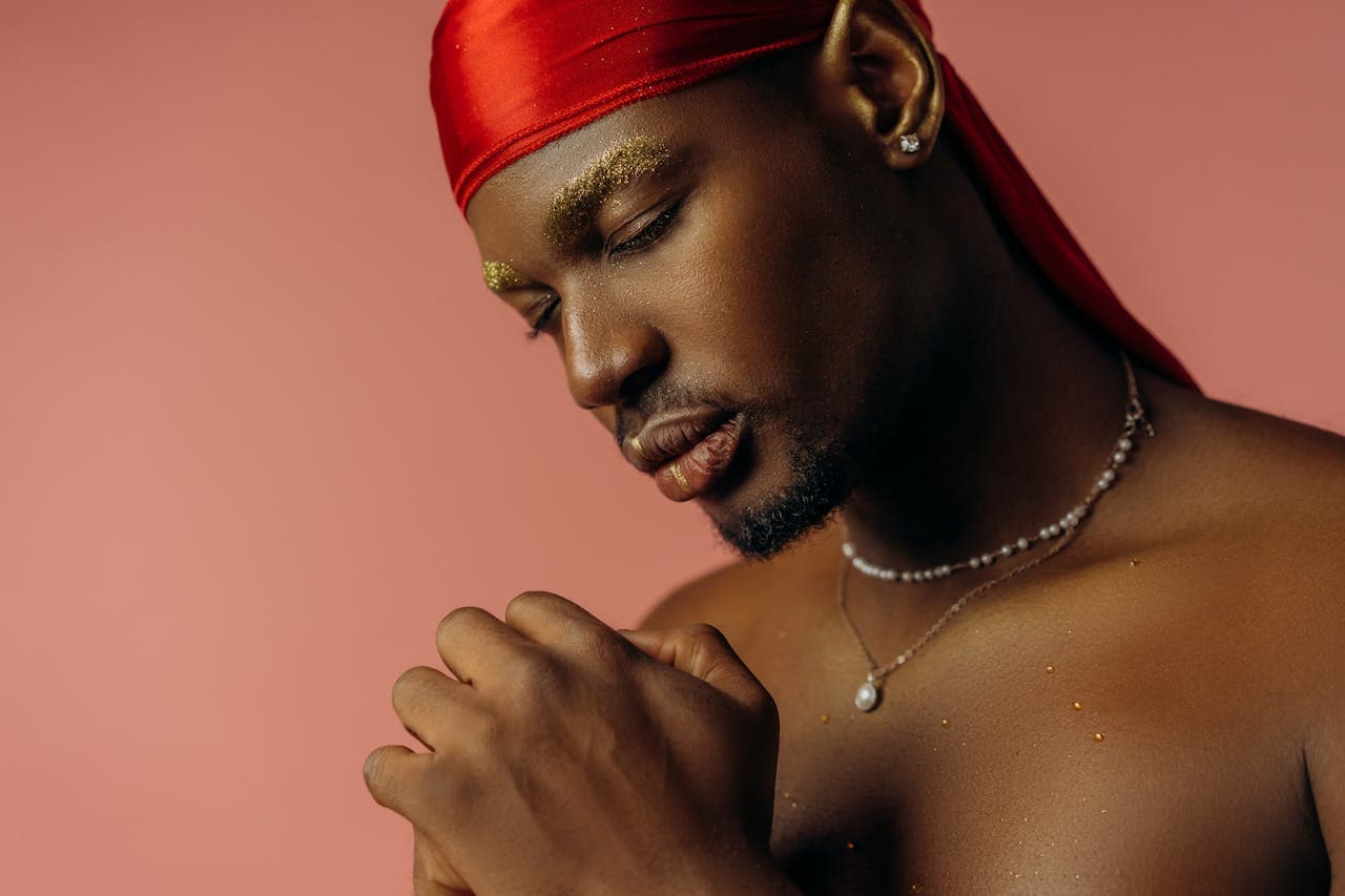 man in red durag in prayer stance